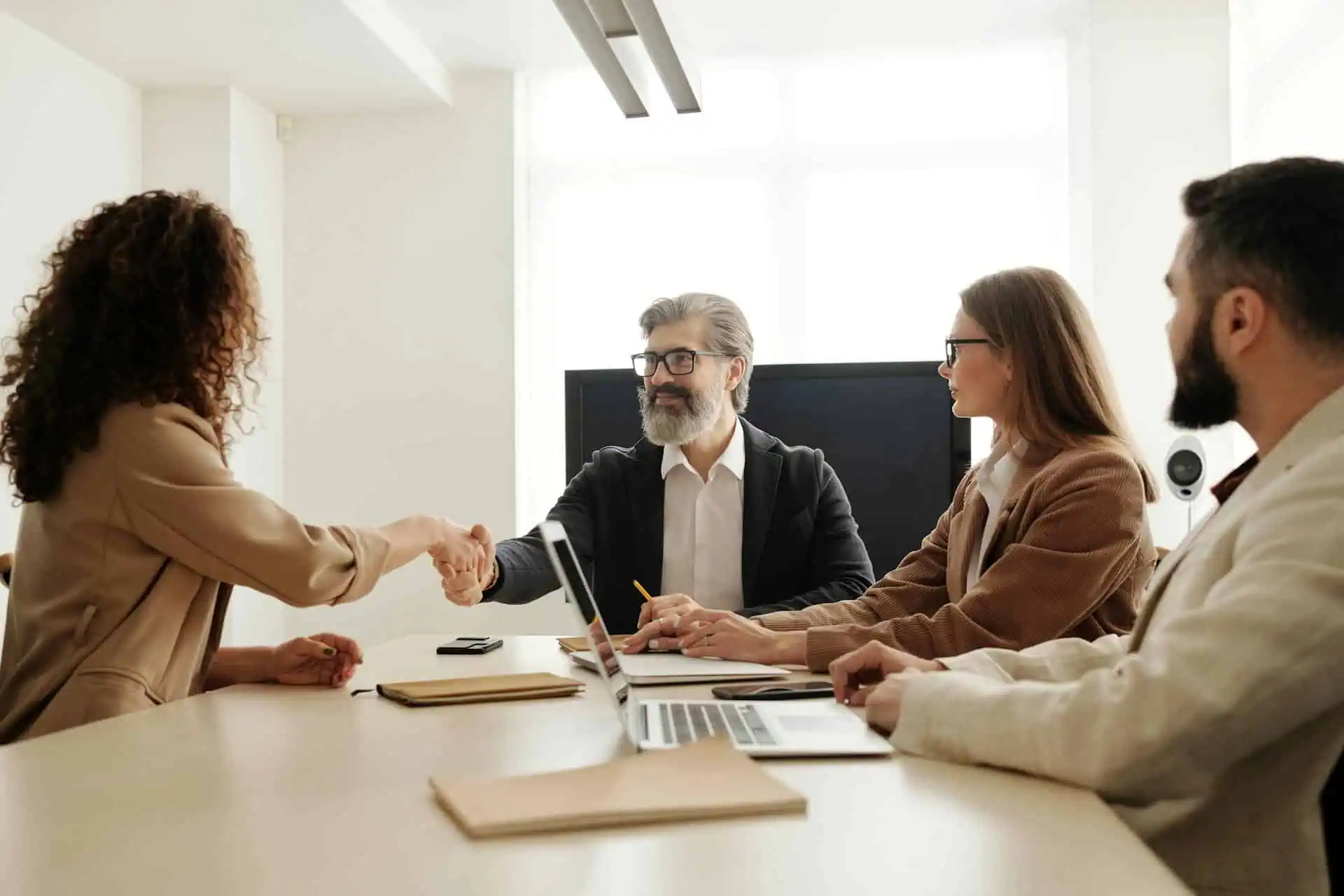 Business team greeting a client in a conference room